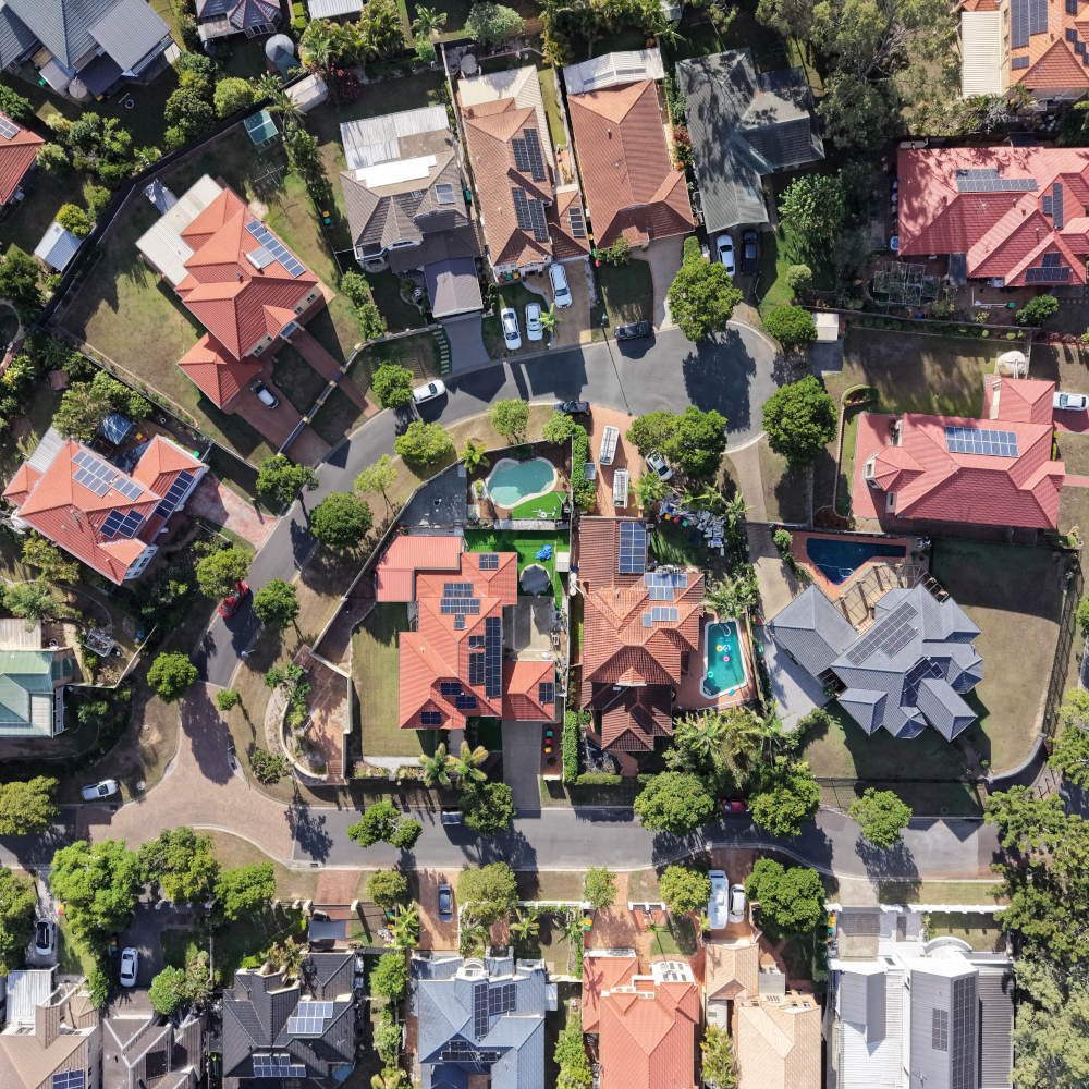 Aerial view of an Australian suburb of homes, several with rooftop solar